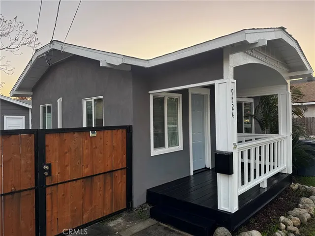a front view of a house with wooden fence