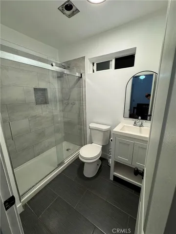 a bathroom with a toilet a sink and a shower