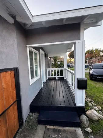 a view of balcony with furniture and wooden floor