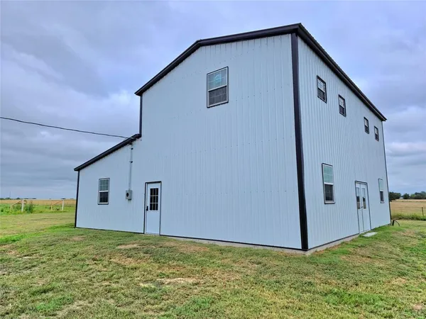 a backyard of a house with a yard and garage