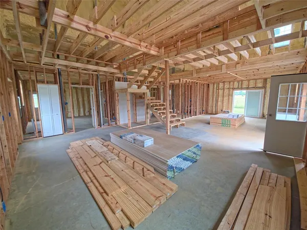 a living room with hard wood floor furniture and a rug