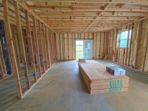 a room with pool table and windows