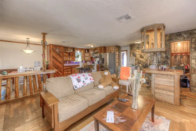 a living room with lots of furniture and a wooden floor