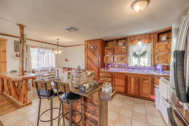 a very nice looking dining room with a large window with kitchen view