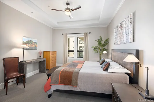 a bedroom with a large bed and potted plant