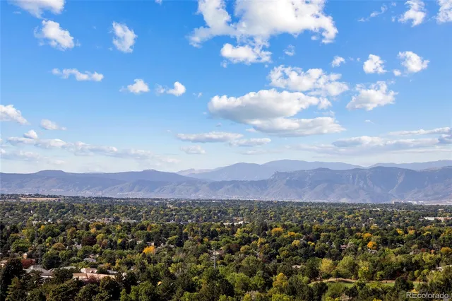 a view of a city with lots of residential buildings and mountain view in back