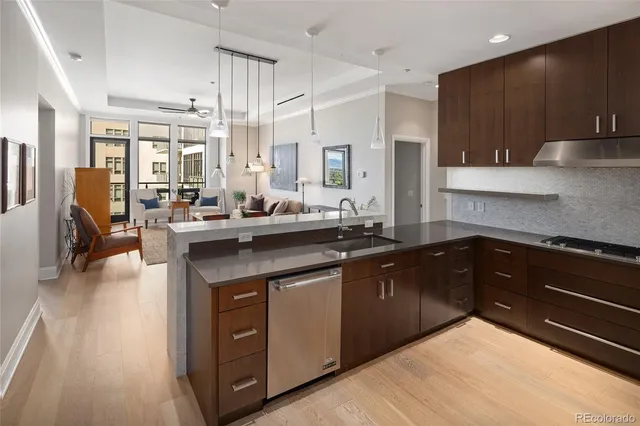 a kitchen with stainless steel appliances kitchen island granite countertop a sink dishwasher stove and oven