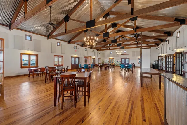 a storage room with stainless steel appliances kitchen island granite countertop a refrigerator and a stove