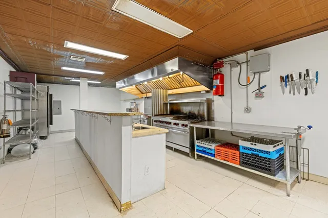 a dining hall with furniture and a fireplace