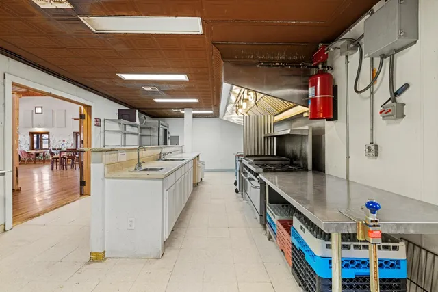 a dining area with lots of furniture and wooden floor