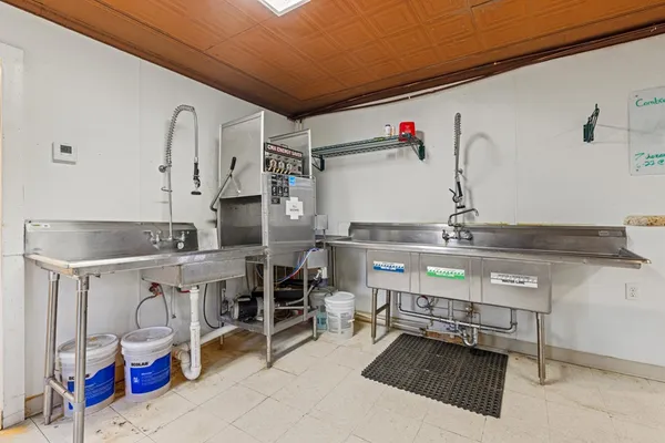 a kitchen with a refrigerator and a stove top oven