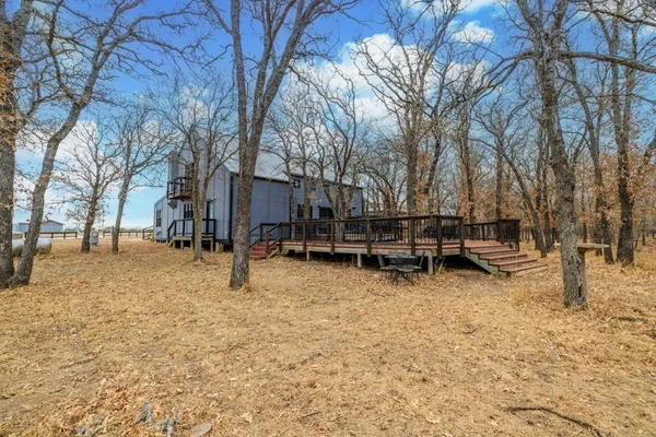 a big house with a big yard and large trees