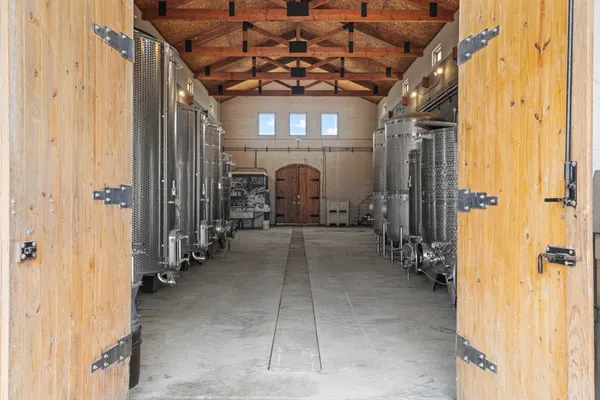 a bedroom with bed and two windows