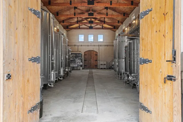 a bedroom with bed and two windows