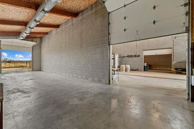 a kitchen with stainless steel appliances kitchen island granite countertop a sink refrigerator and cabinets