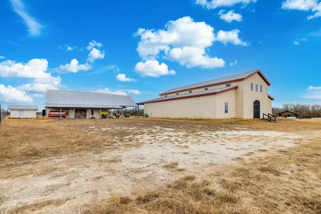 a bathroom with a granite countertop toilet sink and mirror
