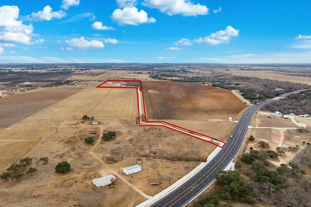a dining room with furniture a chandelier and wooden floor