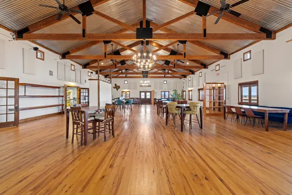 a view of a dining room with furniture wooden floor and a chandelier