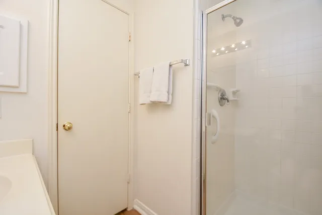 a bathroom with a glass shower door