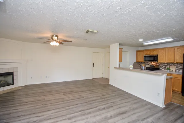 a view of kitchen with sink and wooden floor