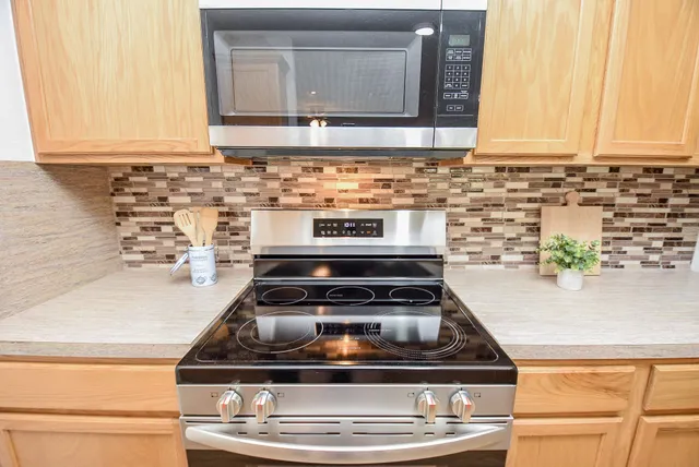 a stove top oven sitting inside of a kitchen