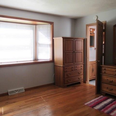 257 Conover Pass Road Acme, PA 15610 - Photo 16 of 25 Bedroom with hardwood floors and a bright "box" window