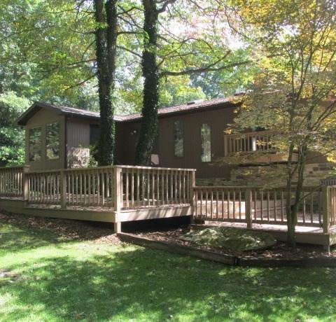 257 Conover Pass Road Acme, PA 15610 - Photo 22 of 25 Imagine entertaining or relaxing after a long day on this incredible deck that wraps most of the way around the back of the home.