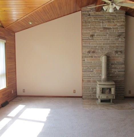 257 Conover Pass Road Acme, PA 15610 - Photo 4 of 25 From the entry hall step down to the large living room with vaulted ceilings, floor to ceiling fire place and incredible natural light.