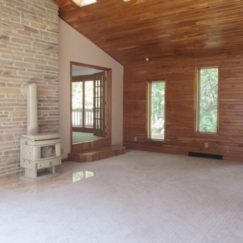 257 Conover Pass Road Acme, PA 15610 - Photo 5 of 25 The 24x17 Family Room boasts a wood-burning stove, cathedral-vaulted cherry wood ceiling and numerous windows and skylights allowing natural light to flood into this gracious space