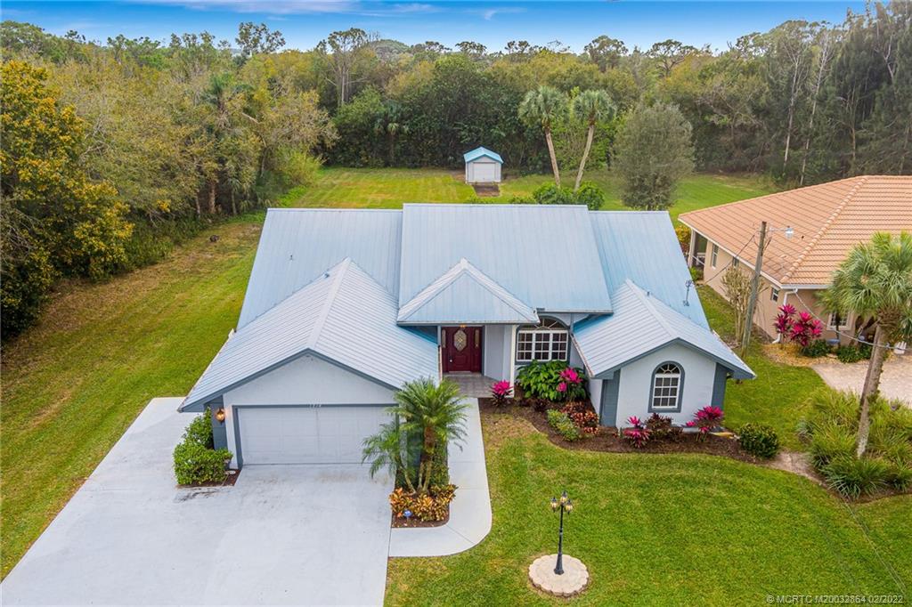1214 Southwest Locks Road Stuart, FL 34997 - Photo 1 of 29 a aerial view of a house with swimming pool and a yard