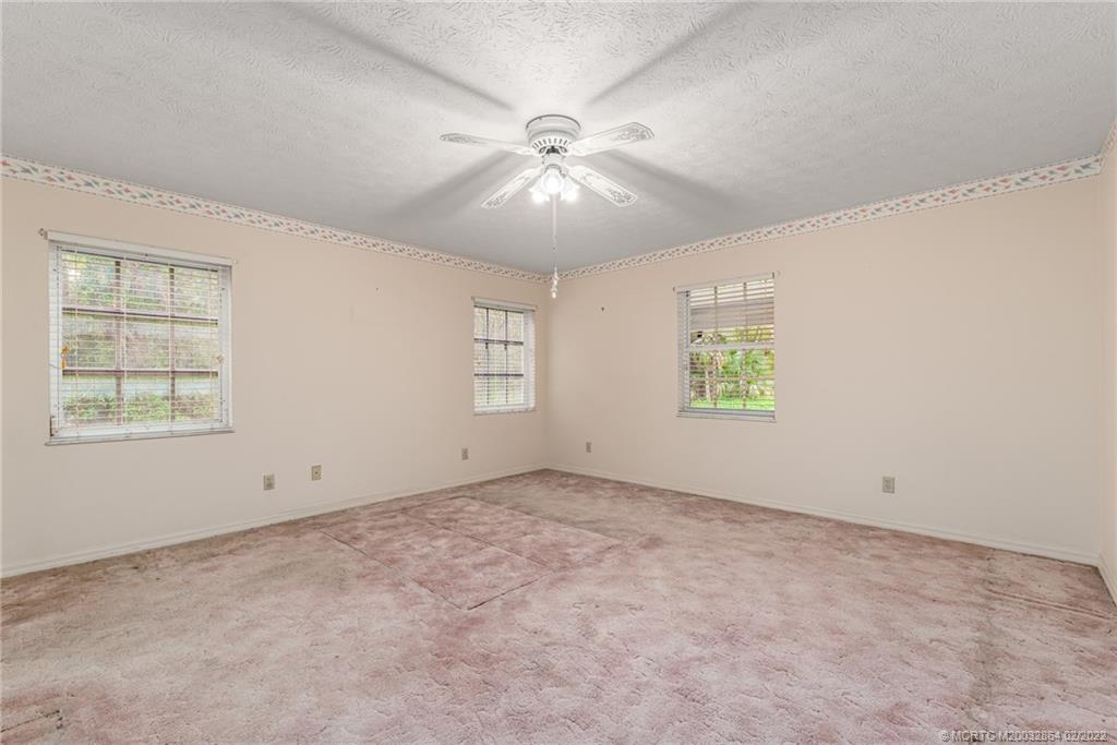 1214 Southwest Locks Road Stuart, FL 34997 - Photo 11 of 29 an empty room with a window and a ceiling fan