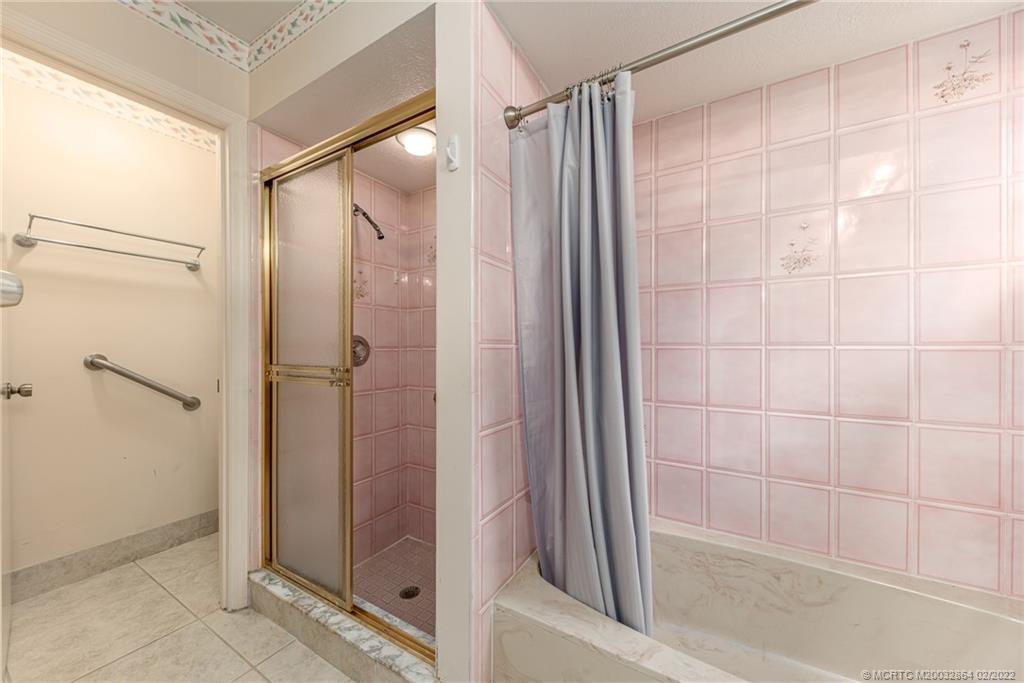 1214 Southwest Locks Road Stuart, FL 34997 - Photo 13 of 29 a bathroom with a glass shower door