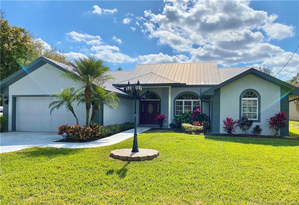 1214 Southwest Locks Road Stuart, FL 34997 - Photo 21 of 29 a front view of a house with garden