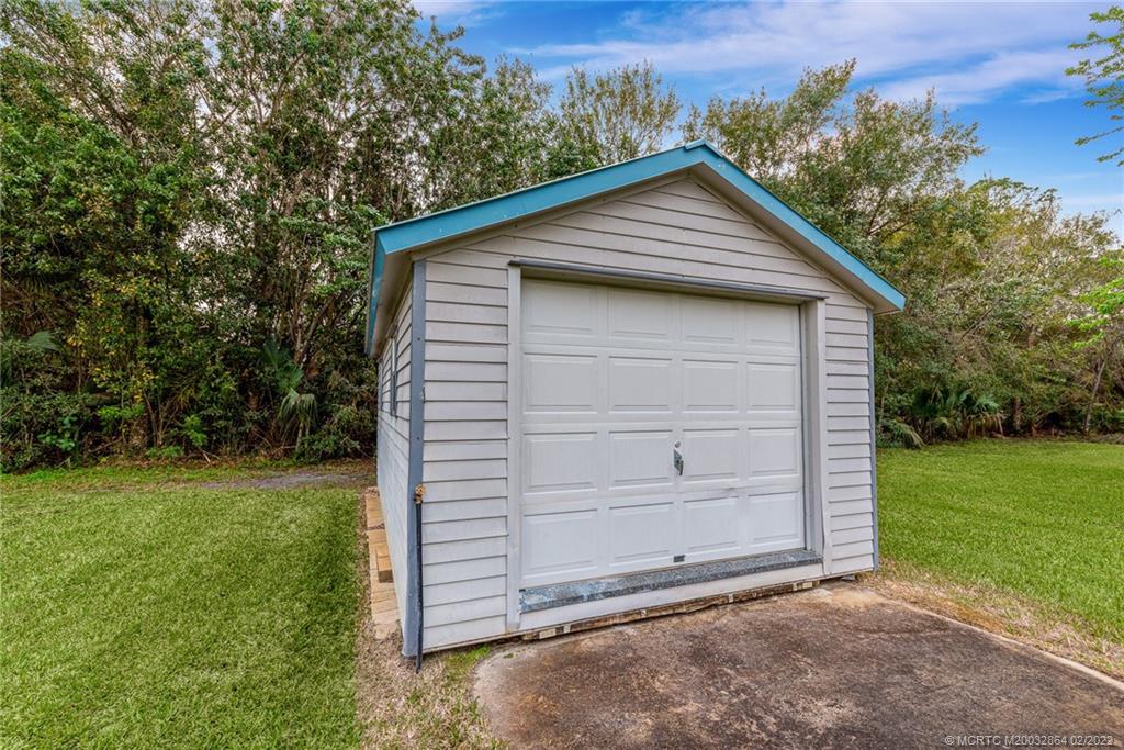 1214 Southwest Locks Road Stuart, FL 34997 - Photo 24 of 29 a view of a house with a yard