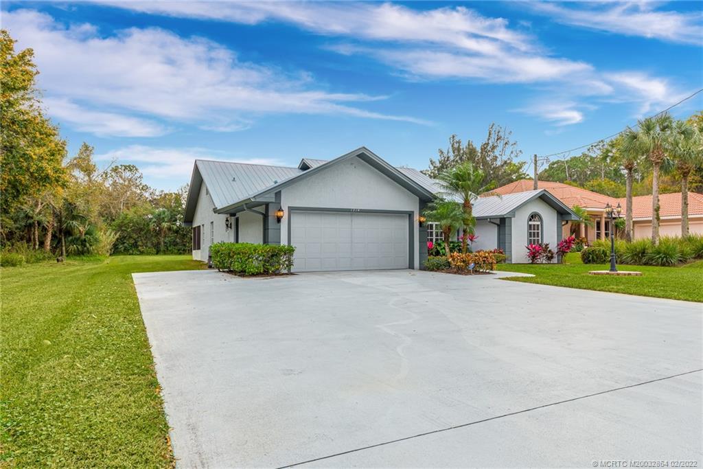 1214 Southwest Locks Road Stuart, FL 34997 - Photo 7 of 29 a front view of house with yard and green space