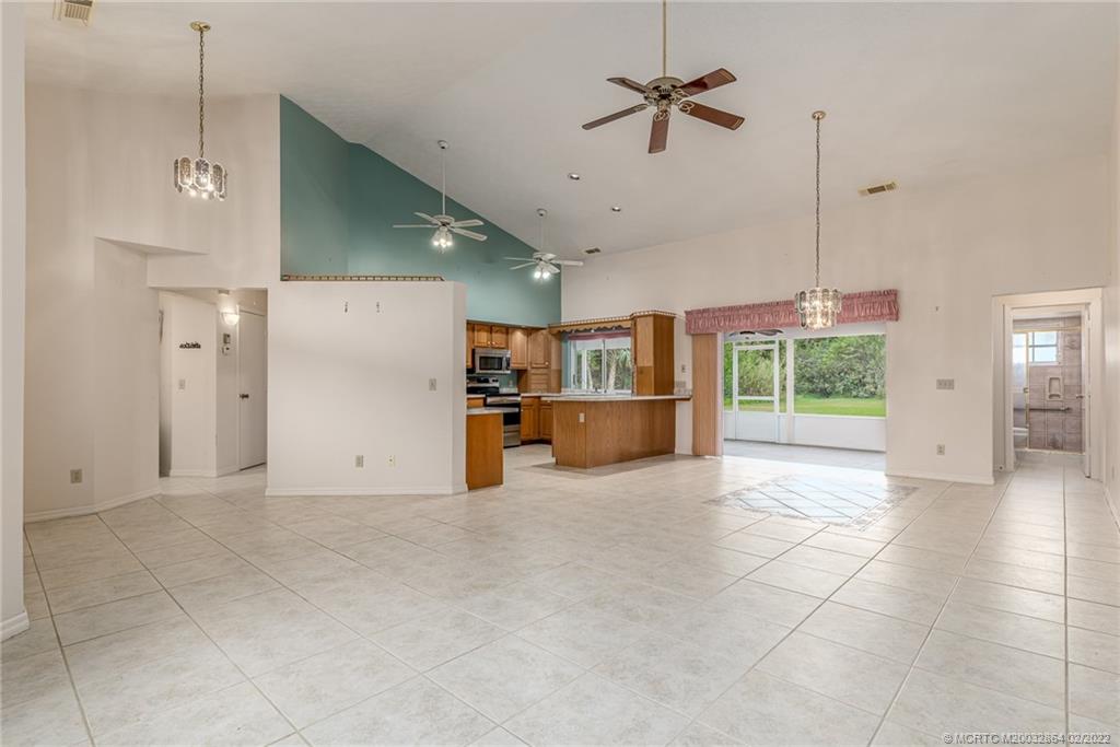 1214 Southwest Locks Road Stuart, FL 34997 - Photo 9 of 29 a view of a kitchen with a sink and a refrigerator