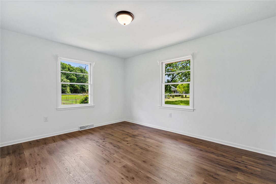 300 Vandiver Road Anderson, SC 29621 - Photo 17 of 30 Rich hardwood floors complement bright windows that frame picturesque outdoor views in this welcoming bedroom.