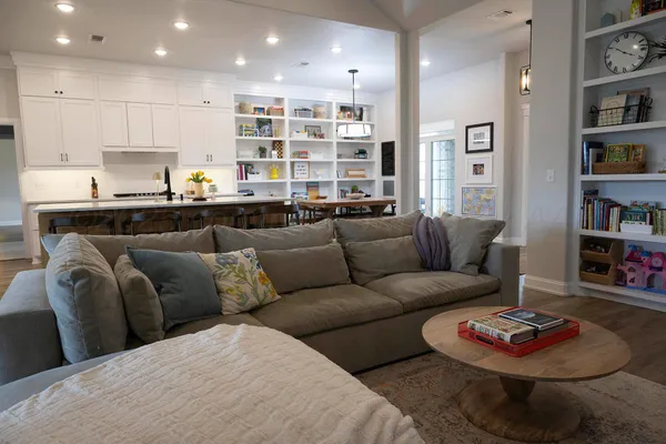 a living room with furniture and a book shelf