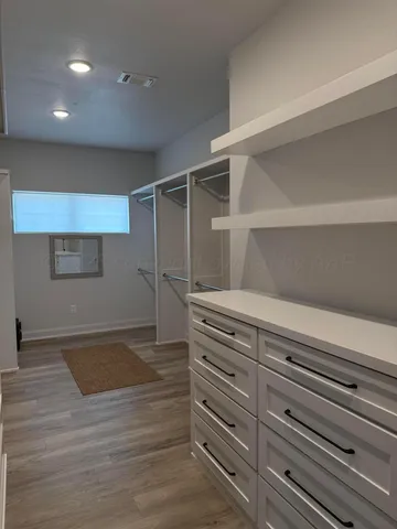 a large room with lots of wooden furniture and windows