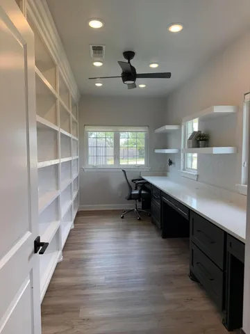a large kitchen with kitchen island a sink a counter space and a window