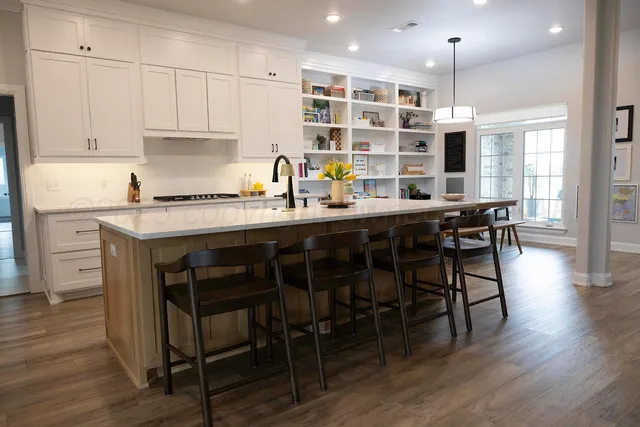 a kitchen with a table chairs stove and cabinets