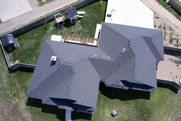 an aerial view of residential houses with yard and ocean view