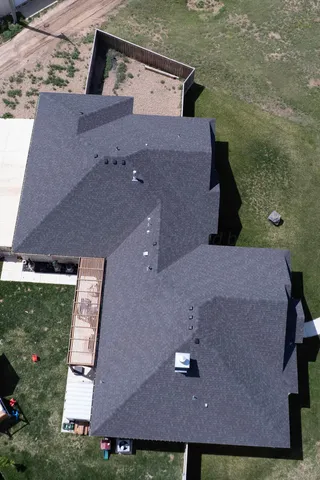 a view of a backyard with a slide and a wooden fence