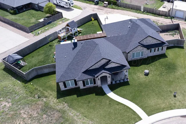 a dining room with a wooden table and chairs