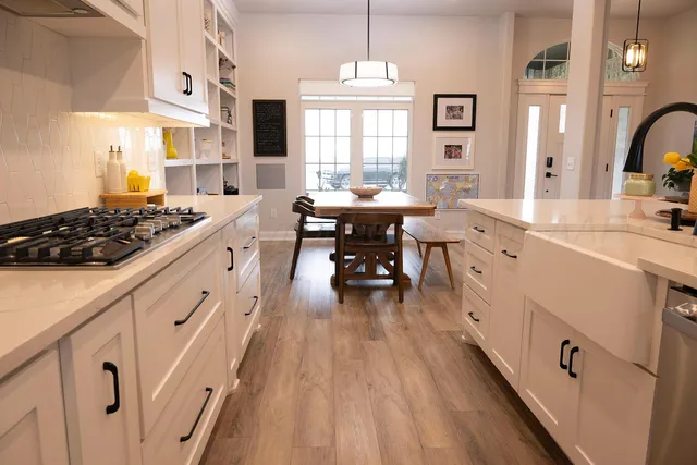 a kitchen with cabinets a sink and appliances