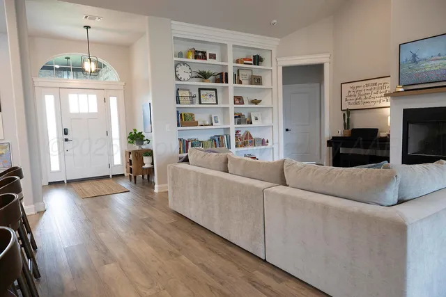 a living room with furniture and a chandelier