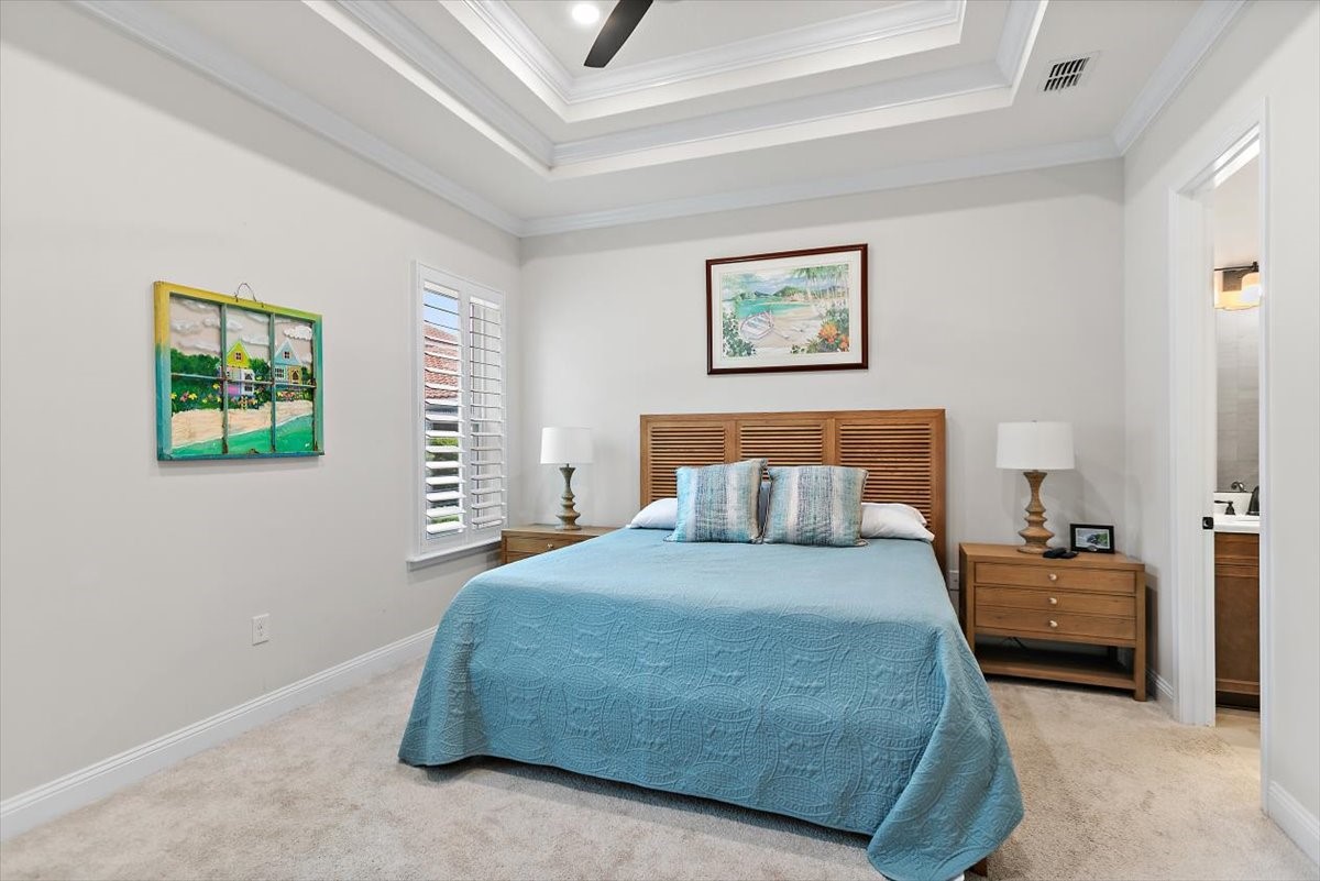 96014 Enclave Manor Fernandina Beach, FL 32034 - Photo 12 of 32 a bedroom with a bed and a lamp on dresser