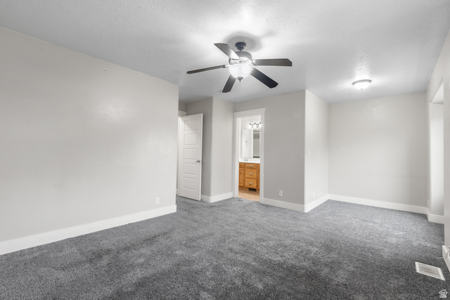 273 West 1010th Street South Logan, UT 84321 - Photo 11 of 19 Unfurnished bedroom with ensuite bathroom, carpet floors, a ceiling fan, and a textured ceiling
