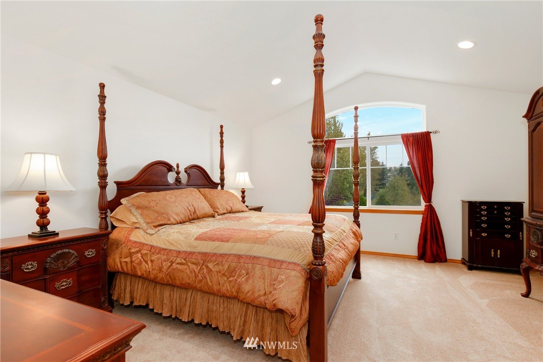 6105 Southeast 3rd Place Renton, WA 98059 - Photo 14 of 24 a bedroom with a bed and a chandelier