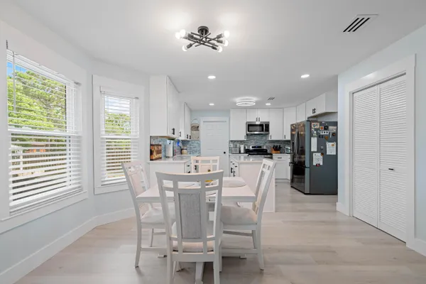 a view of a dining room with furniture and window